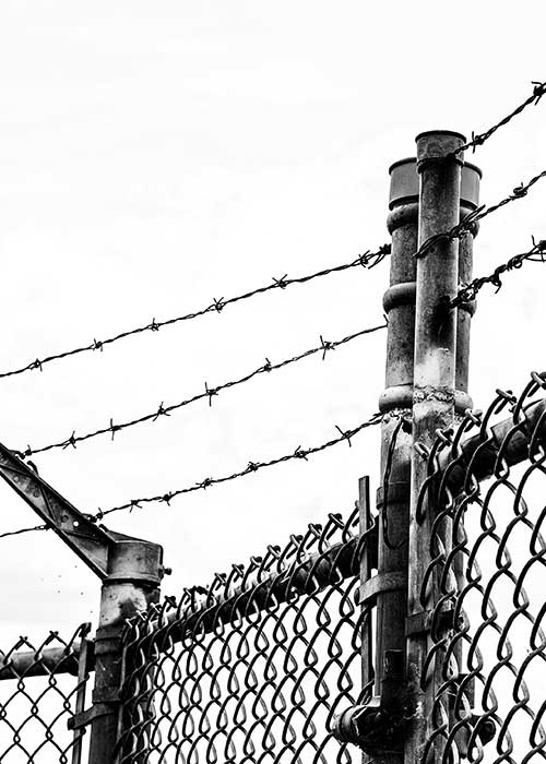 Prison fence against white background
